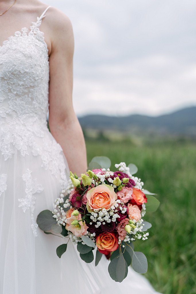 Brautpaar auf einer Bergwiese mit rotem Käfer – Hochzeitsfotografie Mosipictures